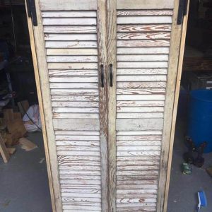 handcrafted pallet cabinet with old shutter doors